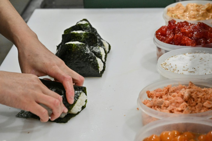A staff member prepares onigiri at the restaurant Onigiri Bongo in the Otsuka area of Tokyo