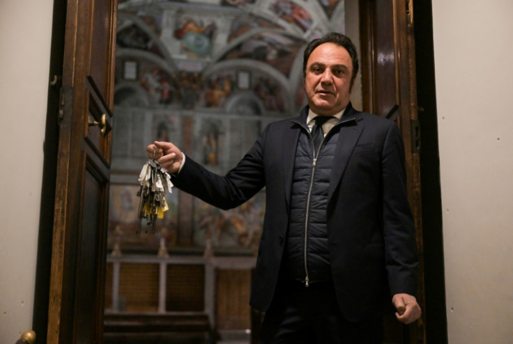 Gianni Crea, key keeper of the Vatican Museums, holds one of the mast of keys at the entrance of the Sistine Chapel from the museums during a private visit by night