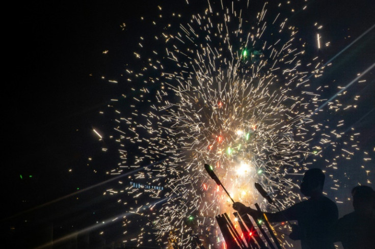 Macau residents and tourists alike light up the night sky with fireworks to celebrate the Lunar New Year of the Dragon