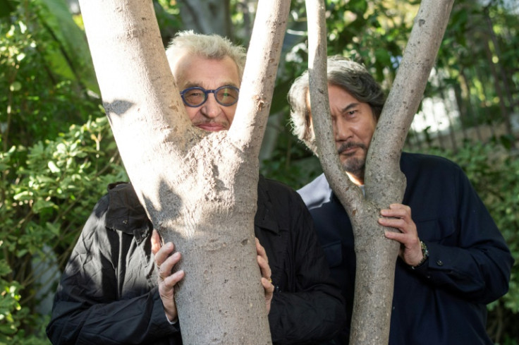 Wenders (L) was impressed there was a Japanese word for light filtering through trees, which actor Koji Yakusho's (R) character films in the movie