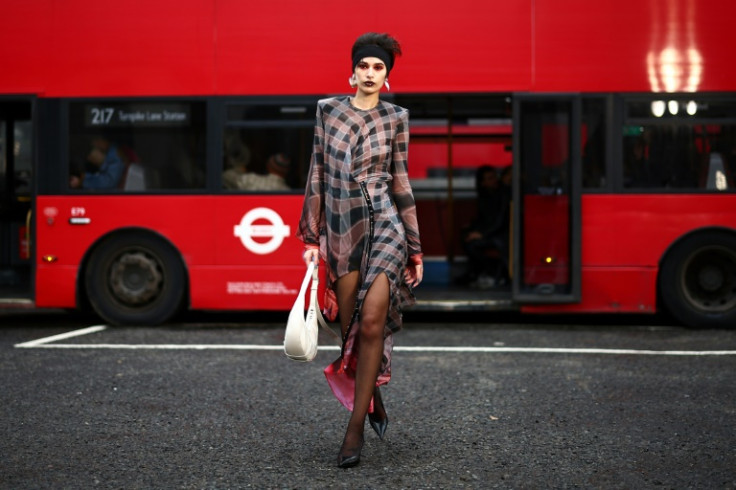 Models paraded in London's famous red double-decker buses in outfits inspired by traditional dance