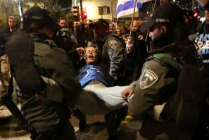 Israeli security force members arrest a protester in Tel Aviv where thousands called for early elections and accused the government of abandoning hostages held in Gaza