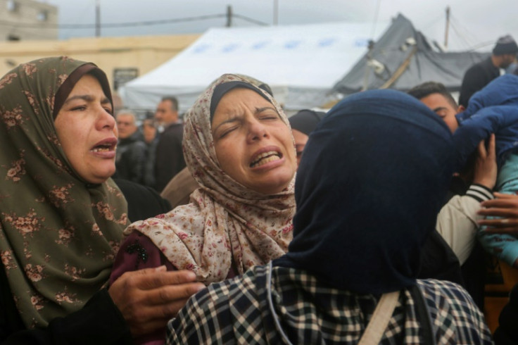 Palestinian women mourn the death of relatives in an Israeli air strike in Gaza's Deir al-Balah