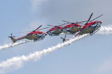 Members of the Sarang Helicopter Display Team of the Indian Air Force (IAF) perform with modified HAL Dhruv helicopters, also known as Advanced Light Helicopter (ALH), during a preview of the Singapore Airshow in Singapore on February 18, 2024