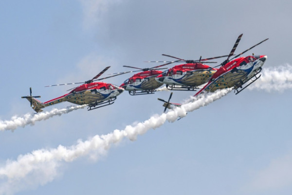The Indian Air Force's Sarang Helicopter Display Team perform with modified HAL Dhruv choppers at a preview of the Singapore Airshow