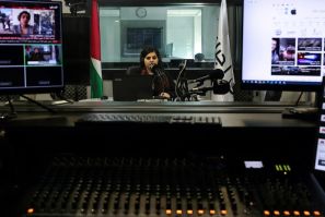 Palestinian radio presenter Maysam Barghouti, 36, sits in the studio at Radio Ajyal