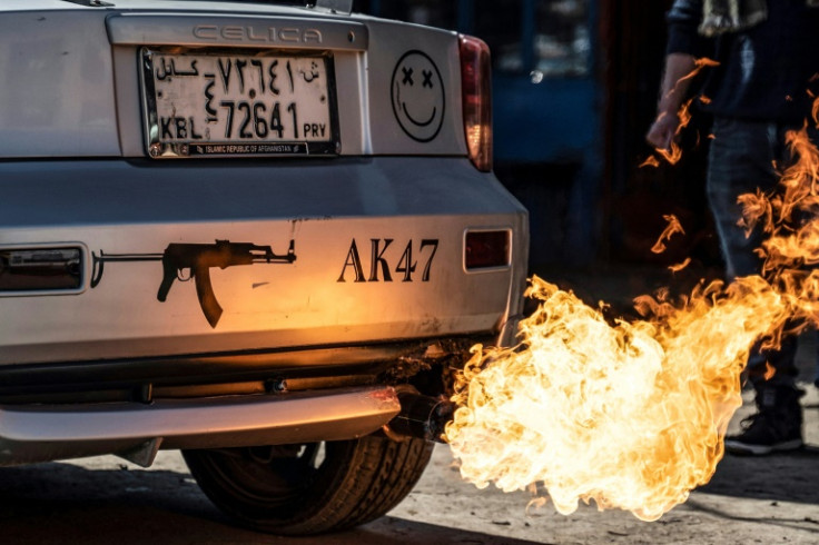 A modified car shoots flames at a workshop in Kabul