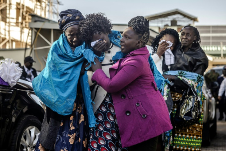 Kiptum's mother Mary Kangongo (C) and his wife Asenath Rotich (2nd R) wept inconsolably
