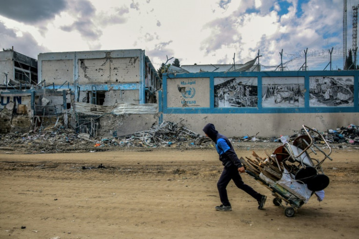 A man walks past the damaged Gaza City headquarters of the United Nations Relief and Works Agency for Palestine Refugees (UNRWA) on February 15, 2024, amid ongoing battles between Israel and the militant group Hamas