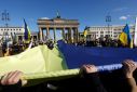 Thousands gathered in front of the Brandenburg Gate waving banners that read 'stand up for Ukraine' and 'arm Ukraine now'
