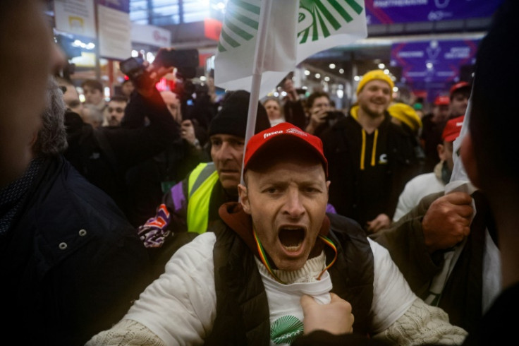 Riot police kept the protesters at a safe distance as Macron toured the fair