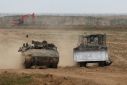 Israeli army vehicles along the border with the Gaza Strip, where plans to establish a security buffer zone are already underway
