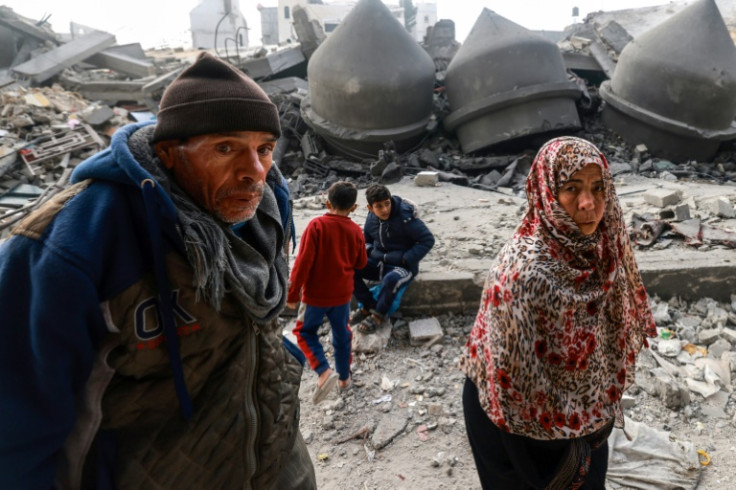 People walk past the Al-Faruq mosque, levelled by Israeli bombardment in Rafah in the southern Gaza Strip