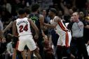 Miami's Jimmy Butler, right, pushes Naji Marshall of the New Orleans Pelicans during an altercation that led the NBA to suspended each for one game