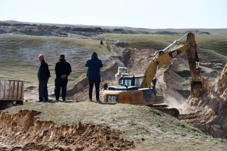 Dirt barriers serve as a temporary measure to stem the flow of contaminated water onto farmland