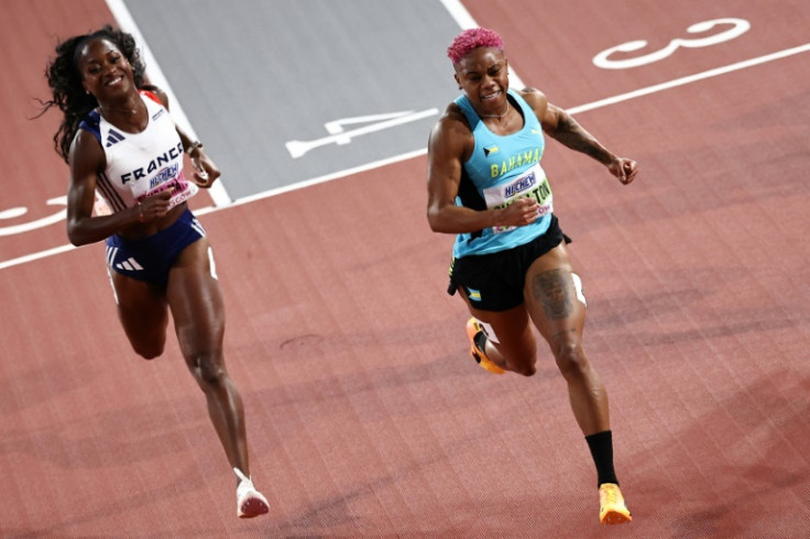 First-placed Bahamas' Devynne Charlton (R) crosses the finish line in the world indoor 60m hurdles