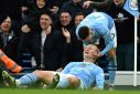 Erling Haaland (centre) and Phil Foden (right) scored in Manchester City's 3-1 win over Manchester United