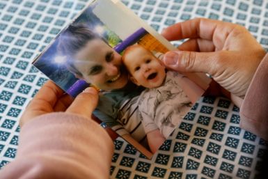 A relative of Shiri Bibas, an Israeli woman kidnaped during the October 7 attack, holds a snapshot of her and one of her two boys