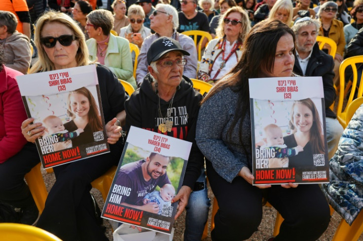 Supporters hold pictures of the Bibas family in Tel Aviv