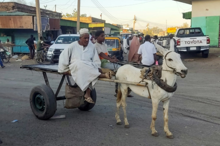 A Sudanese man steers his donkey-drawn cart -- an increasingly common sight once more as war has brought chaos and dire fuel shortages