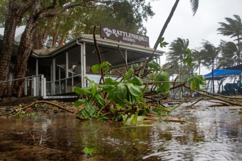 A bar restaurant is seen past fallen branches in Palm Cove as Cyclone Jasper approaches landfall near Cairns in far north Queensland on December 13, 2023.