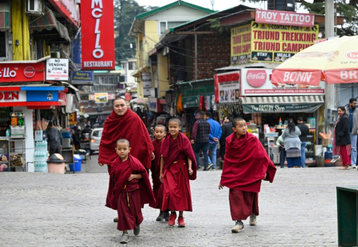 Buddhist monks walk down a street in Dharamsala, India, home to a large number of Tibetan exiles