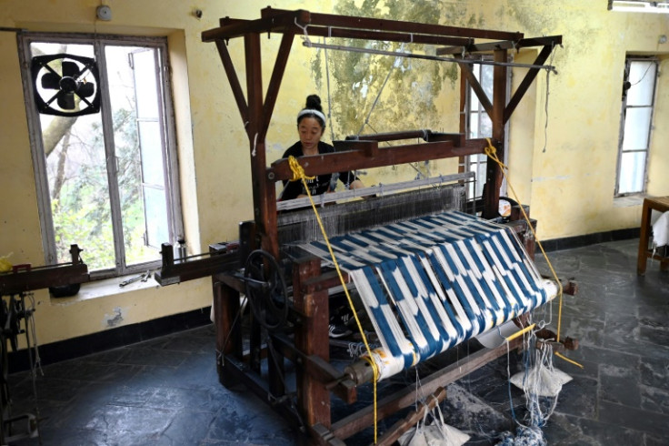 A Tibetan artisan weaves cloth at the Norbulingka Institute, dedicated to preserving Tibetan art and culture