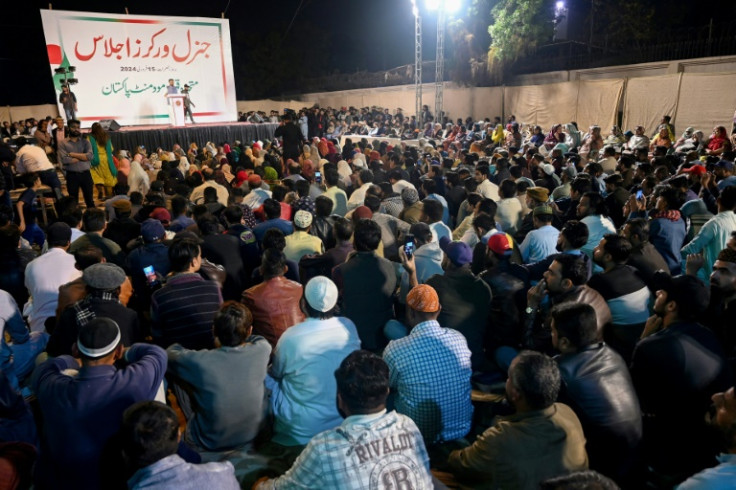 MQM leader Mustafa Kamal (C, addressing supporters) denies a deal with the military was behind the party's rapid return to power