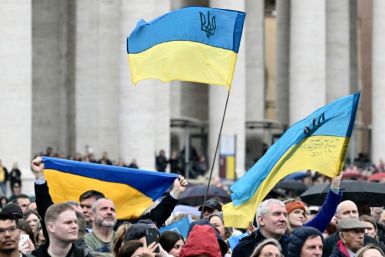 People wave Ukrainian flags at St Peter's square during Pope Francis's Sunday Angelus prayer at the Vatican