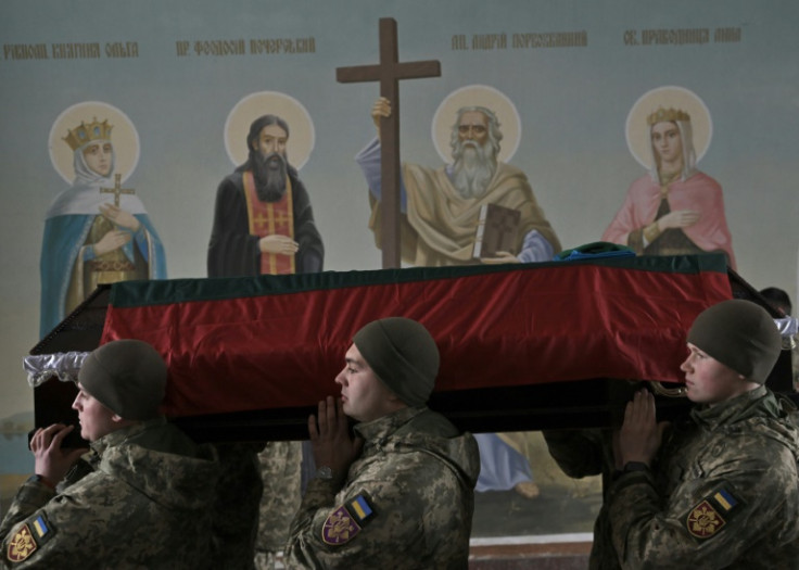 A Ukrainian honor guard carries the coffin of Tadas Tumas, a Lithuanian volunteer killed fighting Russian troops in the Donetsk region, at a service in St. Michael's Golden-Domed cathedral in Kyiv
