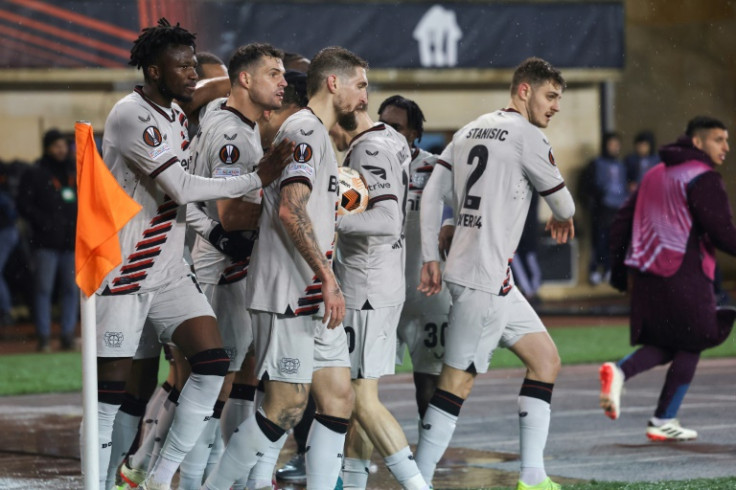 Bayer Leverkusen players celebrate their late equaliser against Qarabag to maintain their unbeaten record