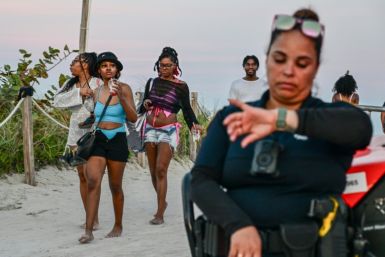 Tourists leave after Miami Beach police closed access on during the Spring Break weekend on March 8, 2024