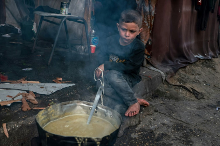 A Palestinian boy in Rafah in the southern Gaza Strip waits for an iftar fast-breaking meal on the second day of the Muslim holy month of Ramadan, on March 12, 2024