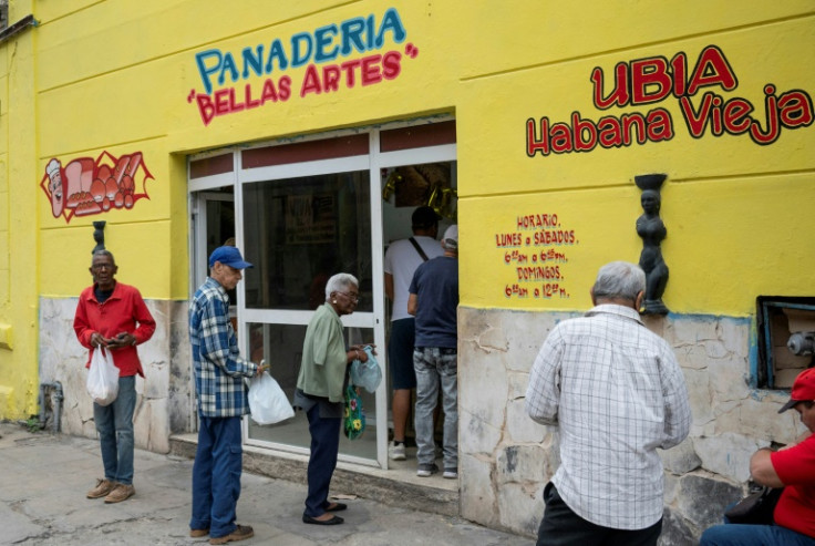 Elderly people queue to buy bread at a bakery in Havana