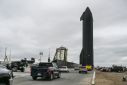 People gather as SpaceX Starship spacecraft prototype is transported from the launch site ahead of the SpaceX Starship third flight test from Starbase in Boca Chica, Texas