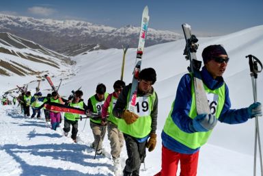 Wearing a hodge-podge of warm clothes and neon pinnies, a long line of competitors shouldered their skis as they marched up the Bamiyan piste, which lacked a lift