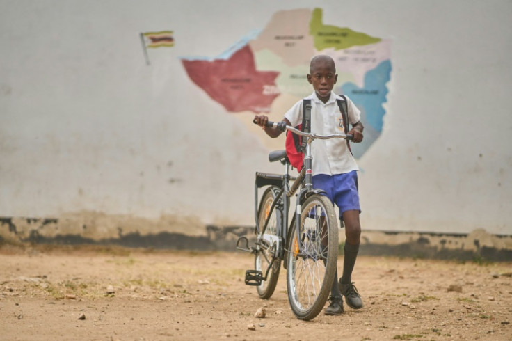 Joaquim Homela is learning to park his new bicycle at school at Mabale primary school near Hwange National Park
