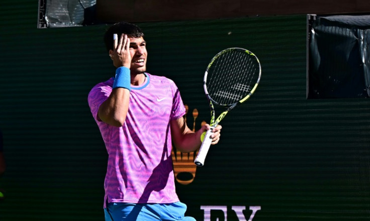 Spain's Carlos Alcaraz reacts to a swarm of bees that halted his men's quarter-final against Germany's Alexander Zverev at the ATP-WTA Indian Wells Masters