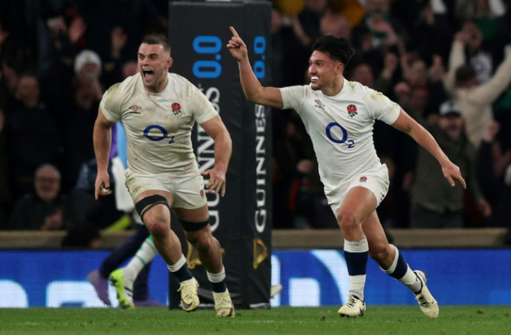 Marcus Smith (R) celebrates scoring the winning drop goal in the win over Ireland