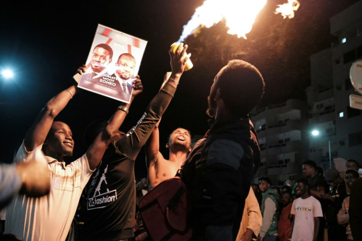 Demonstrators celebrate Senegalese opposition leader Ousmane Sonko's and presidential candidate Bassirou Diomaye Faye's release from prison in Dakar on early March 15, 2024