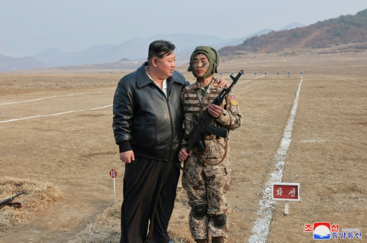 North Korean leader Kim Jong Un encourages a paratrooper during recent drills