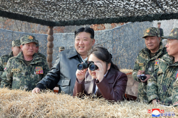 Kim Jong Un's daughter Ju Ae peers through binoculars at a recent training exercise involving North Korean paratroopers