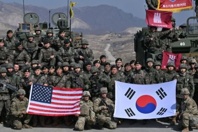 South Korean and US soldiers pose for photos after their joint live fire exercise at a military training field in Pocheon on March 14, 2024 as part of the annual Freedom Shield joint military exercises