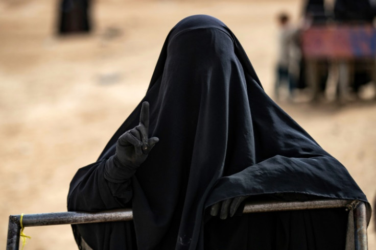 Diehard: A woman in the Al-Hol camp points to the sky -- a gesture long associated with the Islamic State