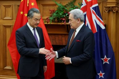 New Zealand Minister of Foreign Affairs Winston Peters (R) shakes hands with Chinese counterpart Wang Yi on Monday in Wellington
