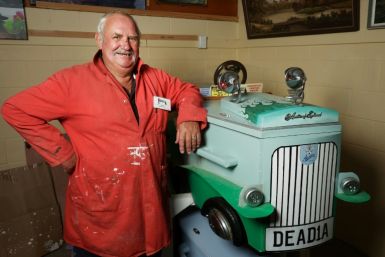 Kevin Heyward poses next to his Austin car coffin that he made at the Coffin Club’s workshop