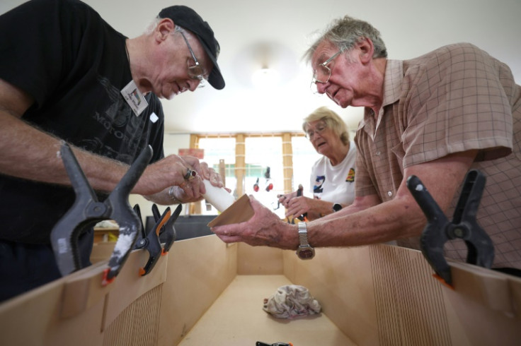Elderly club members meet for cups of tea, a bit of banter, and to literally put the final nail in one-of-a-kind coffins