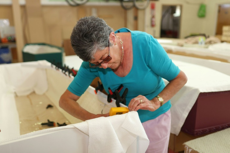Coffin Club organiser Helen Bromley works on the lining of a coffin