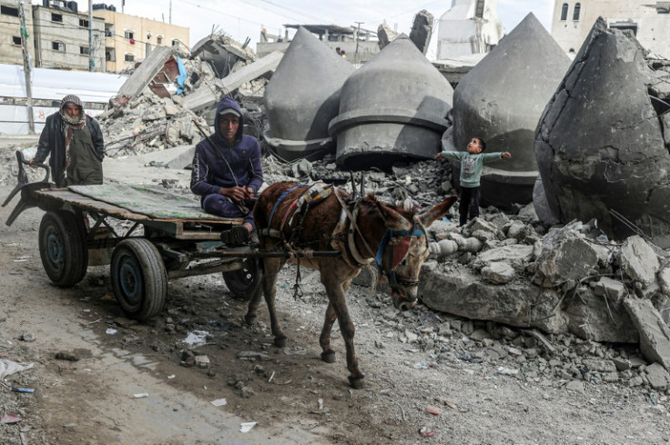 A donkey-pulled cart passes the rubble of Al-Faruq Mosque, destroyed during Israeli bombardment in Rafah, the southern Gaza Strip, where Israel says it will send in ground troops