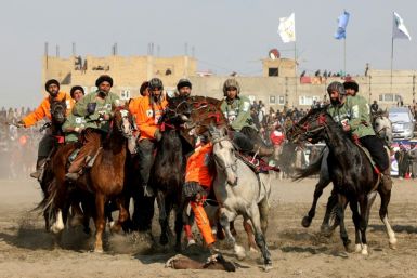 Two teams of buzkashi riders vie for victory in the finals of the rough-and-tumble Afghan sport